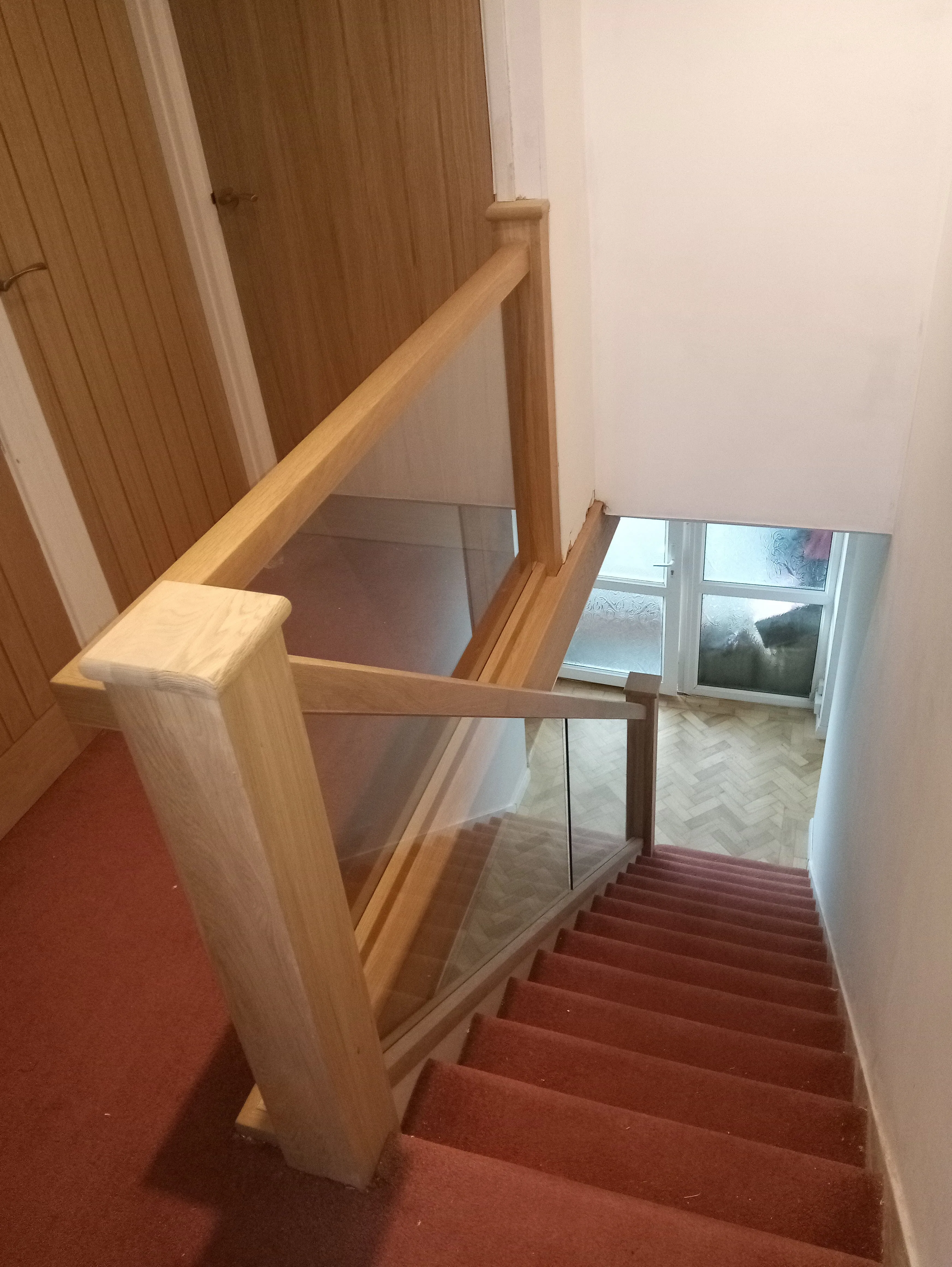 Oak stair handrail and glass panels